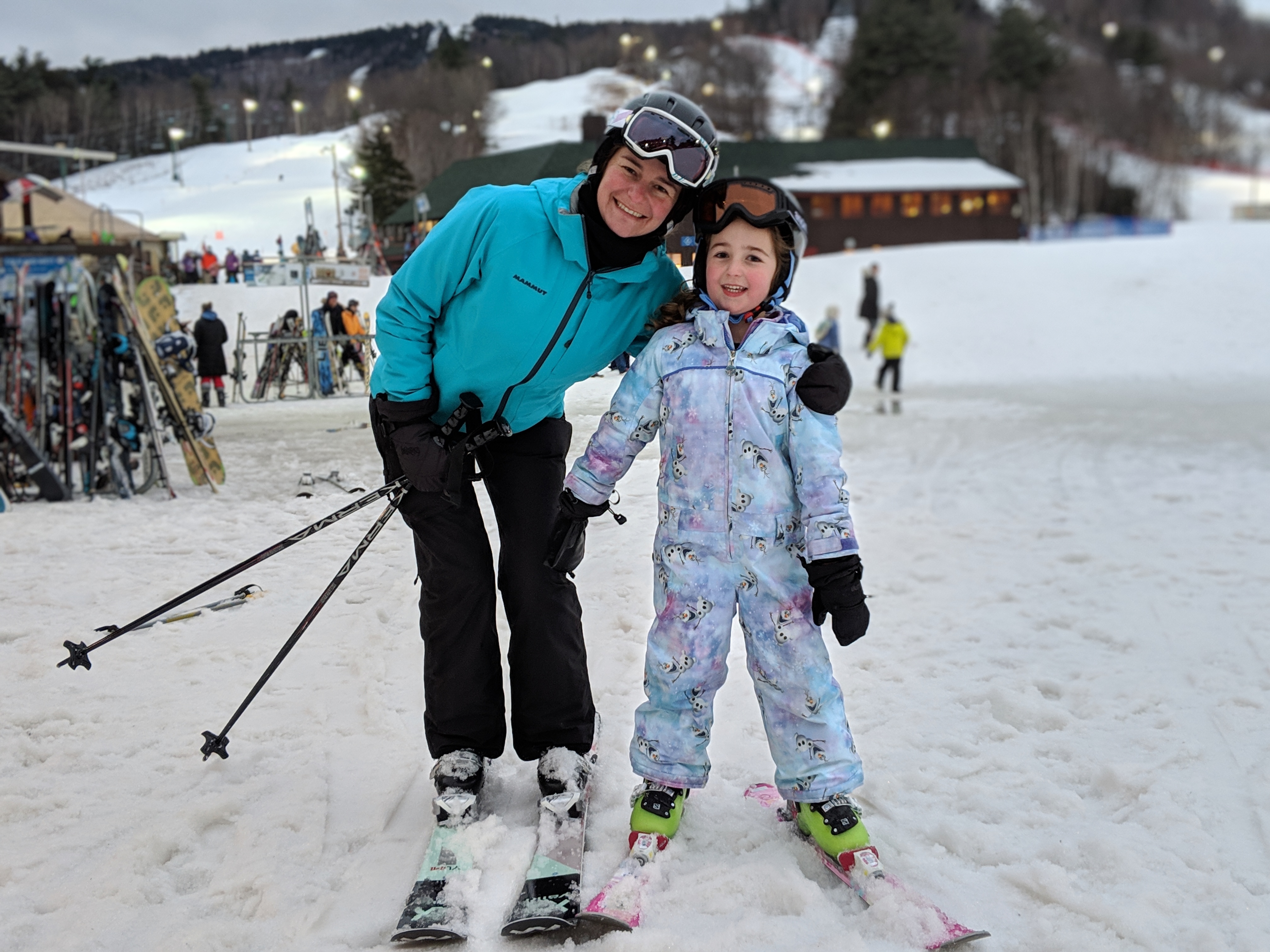 a woman and child on skis