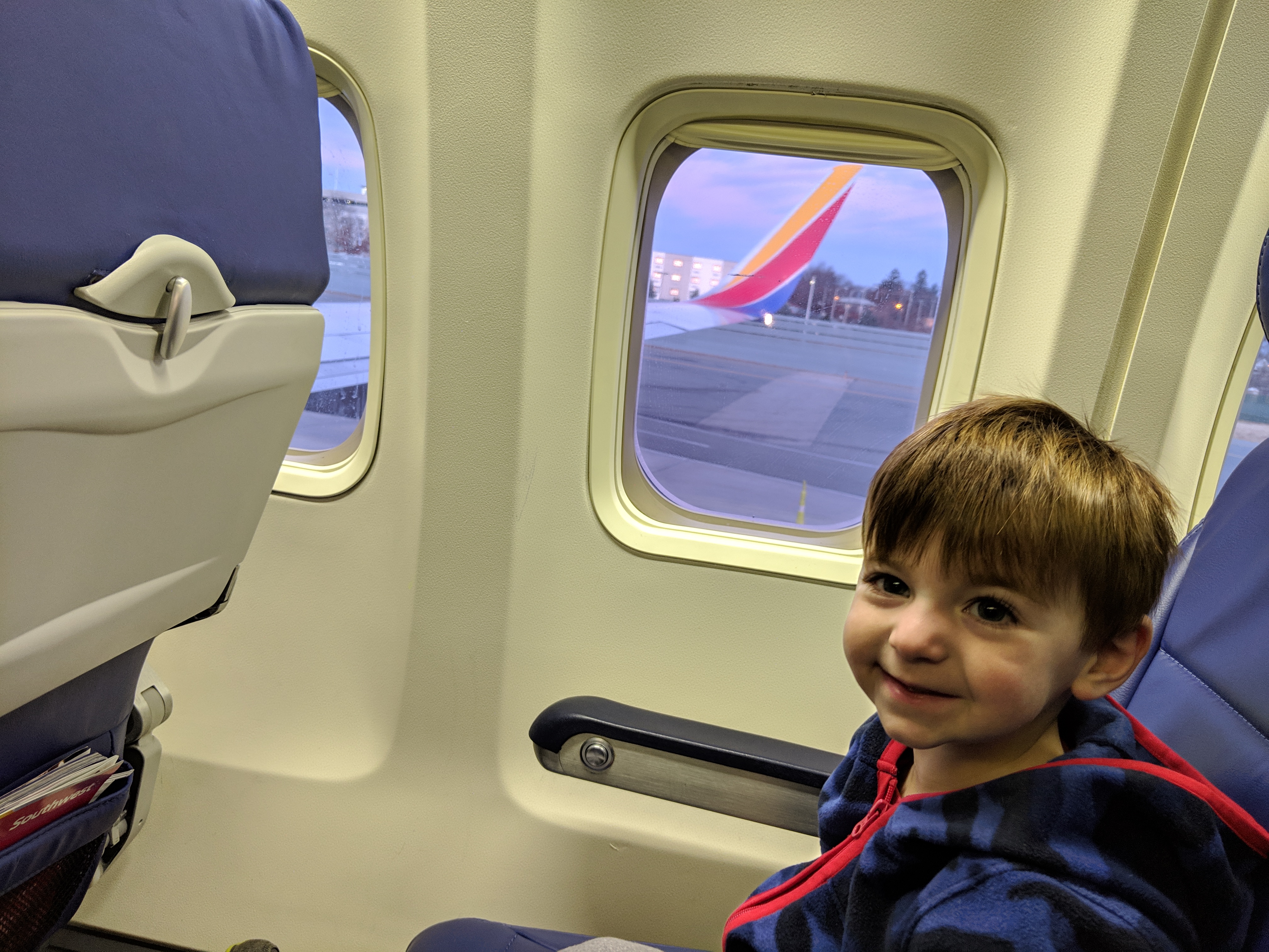 a boy sitting in a plane