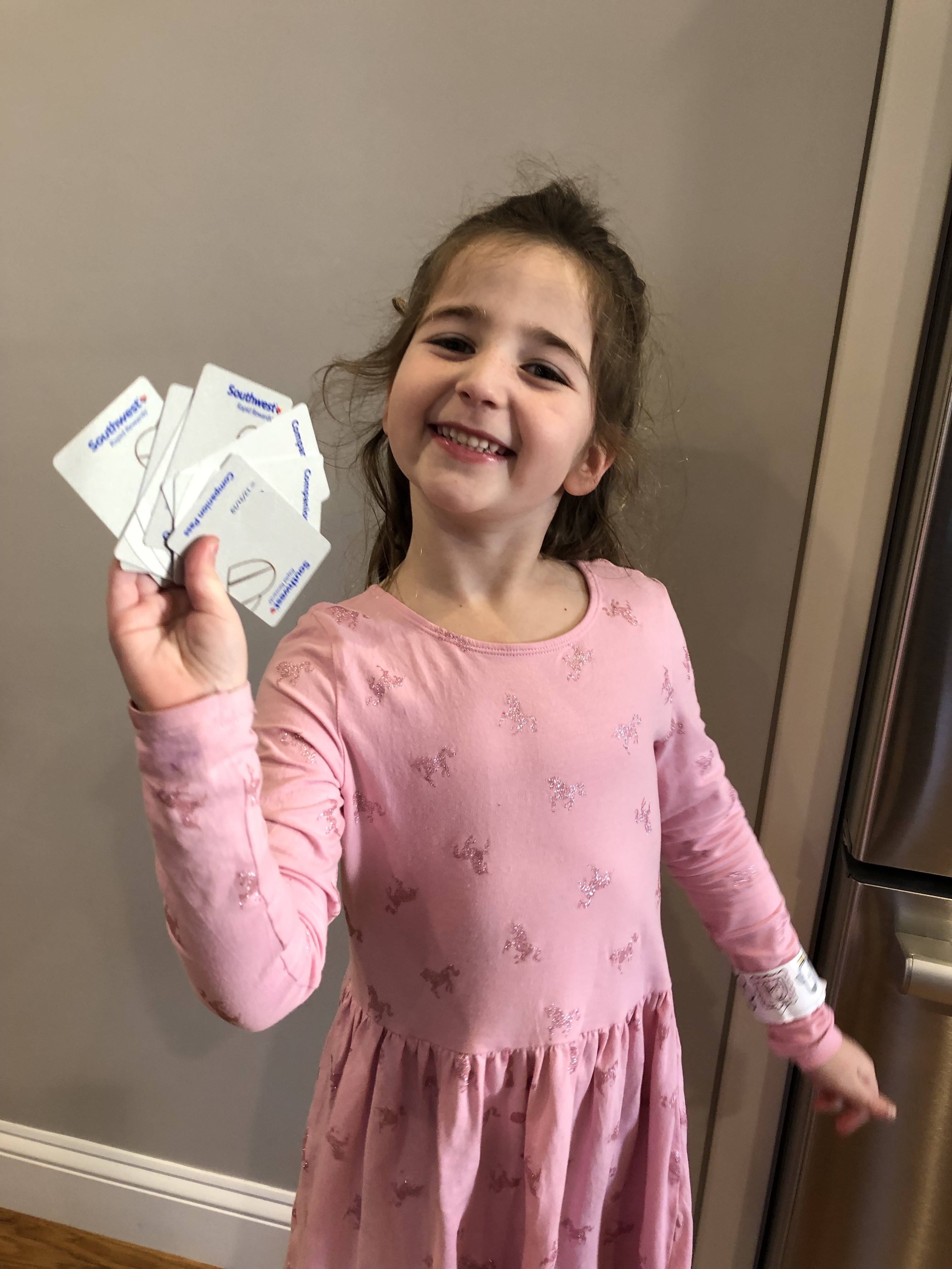 a girl holding up some cards