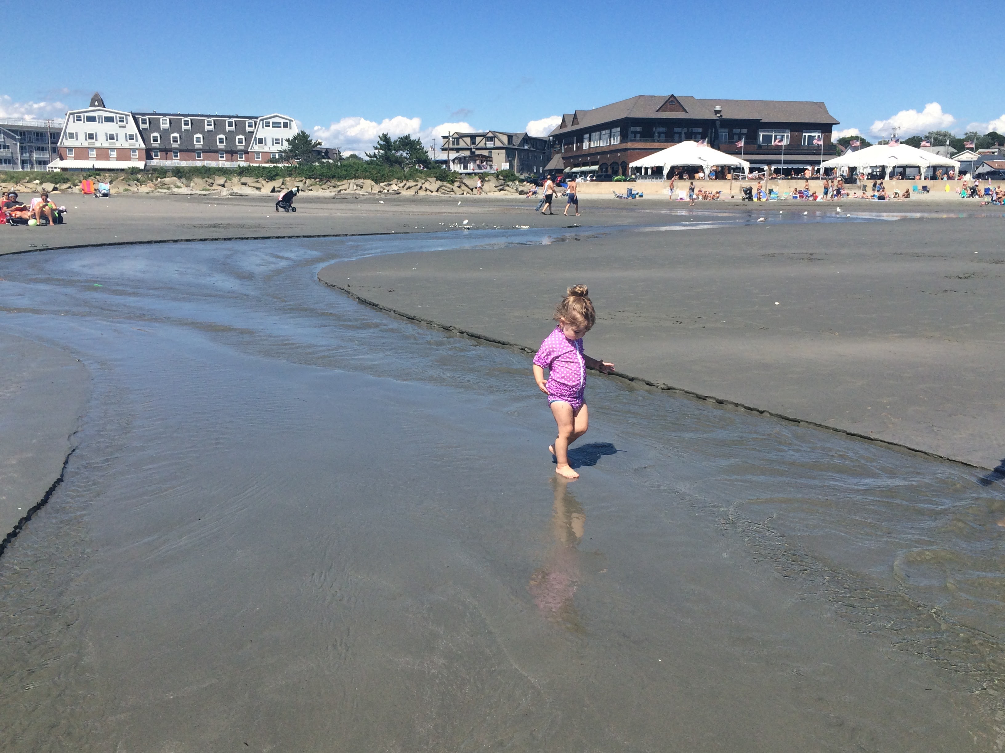 a girl walking on wet sand